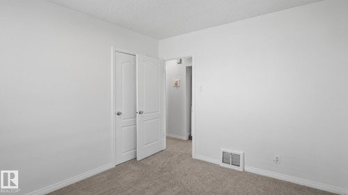 Neutral wall color, wall-to-wall carpeting, and white trim - 11836 62 Street Nw, Edmonton, AB 