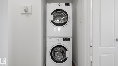Stacked white front-loading washer and dryer units - 11836 62 Street Nw, Edmonton, AB 