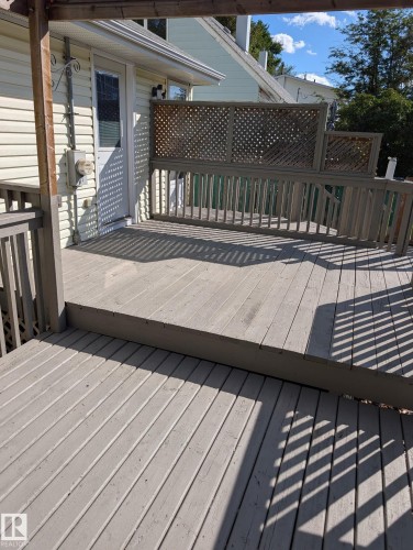 Multi-level deck featuring wood construction, lattice privacy screening, and a direct entrance to the residence - 11836 62 Street Nw, Edmonton, AB 