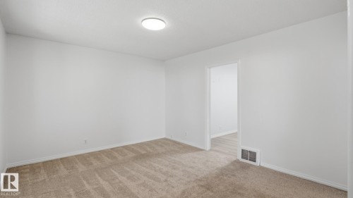 Neutral wall tones, carpeted flooring, and a flush-mount ceiling light - 11836 62 Street Nw, Edmonton, AB 