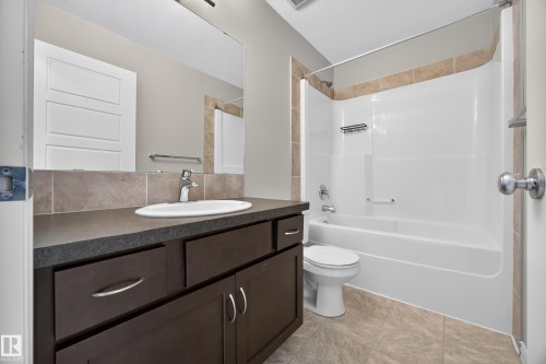 Vanity with dark cabinetry and a vessel sink - 483 Watt Boulevard Sw, Edmonton, AB 
