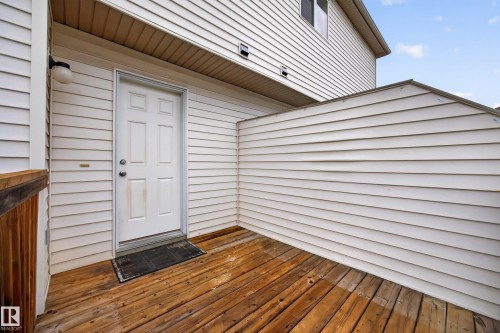 Wood-finish deck with privacy wall and exterior lighting - 483 Watt Boulevard Sw, Edmonton, AB 