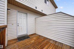 Wood-finish deck with privacy wall and exterior lighting - 