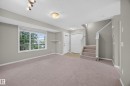 Expansive carpeted living area with a large window - 483 Watt Boulevard Sw, Edmonton, AB 