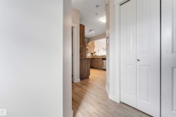 Wood-finish flooring throughout, white paneled bi-fold doors, and recessed lighting - 