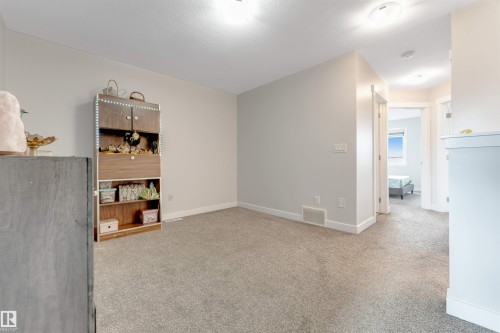 Neutral wall paint, light gray carpeting, recessed lighting, and white trim - 2004 15 Avenue Nw, Edmonton, AB 