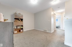 Neutral wall paint, light gray carpeting, recessed lighting, and white trim - 