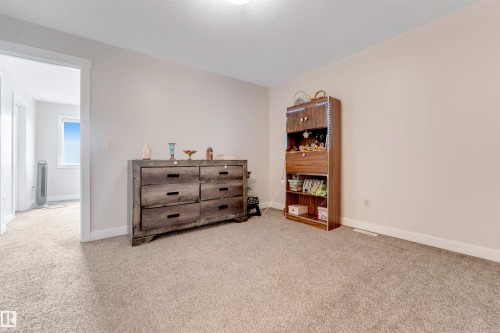 Neutral wall paint, light-toned carpet flooring, and white trim - 2004 15 Avenue Nw, Edmonton, AB 