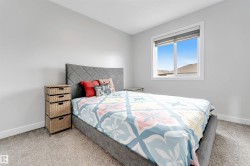 Carpeted flooring, white trim, and a window with a roller shade - 