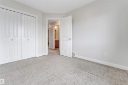Neutral-toned carpeting, white bi-fold closet doors, and white interior doors - 