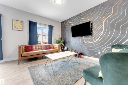 Accent wall with curvilinear pattern, wood-finish flooring, and white trim - 2004 15 Avenue Nw, Edmonton, AB 