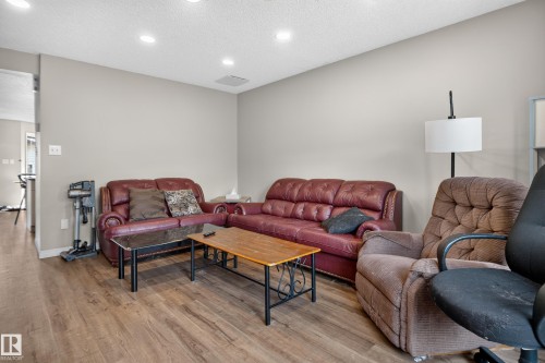 Recessed lighting throughout, wood-finish flooring, and neutral wall tones - 7817 Schmid Place Nw, Edmonton, AB 