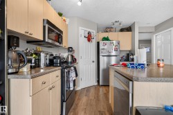 Kitchen featuring wood-finish cabinetry, stainless steel appliances, and a built-in microwave - 