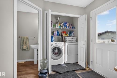 Dedicated laundry closet with built-in shelving - 7817 Schmid Place Nw, Edmonton, AB 