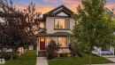 Two-story residence with light-colored siding and dark trim - 7817 Schmid Place Nw, Edmonton, AB 
