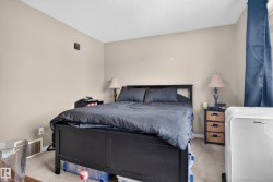 Textured ceiling, neutral wall paint, and carpet flooring - 
