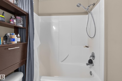 White tub and shower combination with chrome fixtures - 7817 Schmid Place Nw, Edmonton, AB 