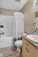 Bathtub with shower, toilet, and vanity with an integrated sink - 