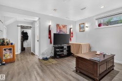 Wood-finish flooring throughout, recessed ceiling lighting, and a white trim window - 