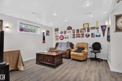 Recessed lighting, wood-finish flooring, white baseboards, and a window for natural light - 