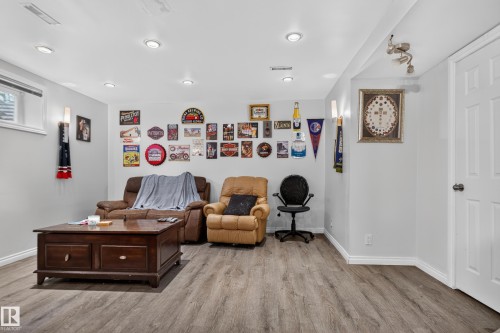 Recessed lighting, wood-finish flooring, white trim, and a window - 7817 Schmid Place Nw, Edmonton, AB 