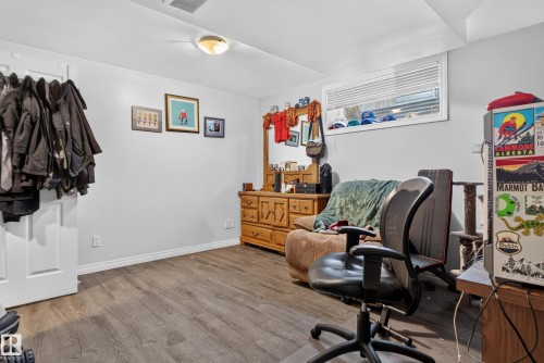 Wood-finish flooring throughout the space - 7817 Schmid Place Nw, Edmonton, AB 