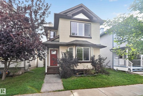 Two-story residence featuring light-colored siding and dark trim - 7817 Schmid Place Nw, Edmonton, AB 