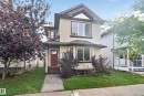 Two-story residence featuring light-colored siding and dark trim - 7817 Schmid Place Nw, Edmonton, AB 