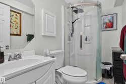 White vanity with integrated sink, chrome faucet, and mirrored cabinet - 