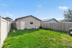 Detached garage with siding exterior and a single entry door - 