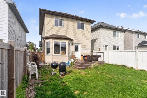 Rear exterior with neutral-toned siding, bay window, and a ground-level deck - 7817 Schmid Place Nw, Edmonton, AB 