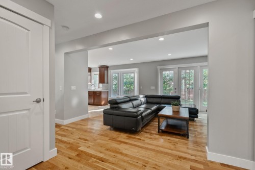 Light wood-finish flooring throughout, recessed ceiling lighting, gray wall paint, and white trim - 12403 29A Avenue Nw, Edmonton, AB 