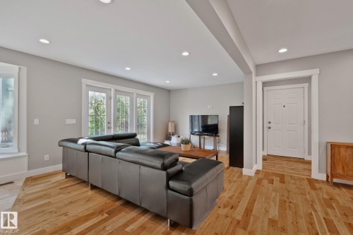 Hardwood flooring, recessed lighting, white trim, and a white paneled front door - 12403 29A Avenue Nw, Edmonton, AB 