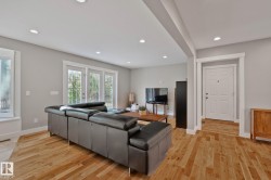 Hardwood flooring, recessed lighting, white trim, and a white paneled front door - 