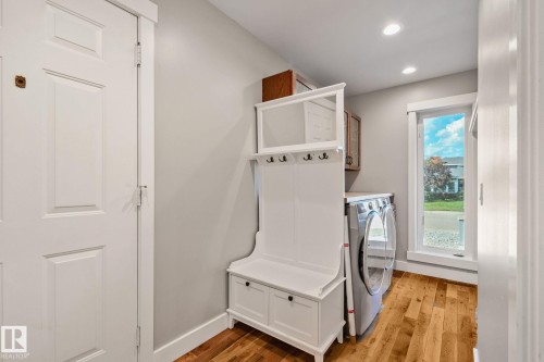 Hardwood flooring, recessed lighting, built-in storage bench, paneled entry door, and a tall window - 12403 29A Avenue Nw, Edmonton, AB 