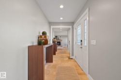 Recessed lighting, light-toned wall finishes, double entry doors with decorative glass inserts, and square tile flooring - 