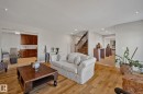 Hardwood flooring, recessed lighting, a built-in wet bar with wood cabinetry, and a wood staircase with dark railing - 12403 29A Avenue Nw, Edmonton, AB 