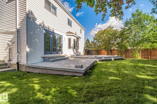 Expansive green lawn with a large multi-level patio - 12403 29A Avenue Nw, Edmonton, AB 