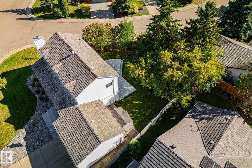 Gable roofline with dormer windows, white siding exterior, paved driveway, mature trees, and a manicured lawn - 12403 29A Avenue Nw, Edmonton, AB 