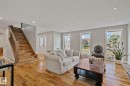 Hardwood flooring, painted walls, recessed lighting, wood staircase with metal balusters, and multiple windows - 12403 29A Avenue Nw, Edmonton, AB 