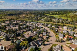 Residential neighborhood with mature trees, established streets, and proximity to expansive green spaces and a golf course - 