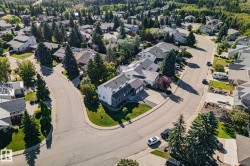 Curved street with surrounding residential properties, mature trees, and landscaping - 
