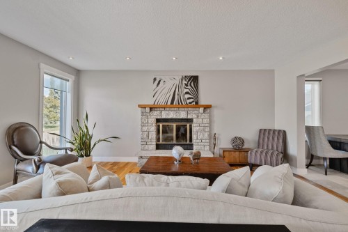 Stone-clad fireplace with wood mantel - 12403 29A Avenue Nw, Edmonton, AB 