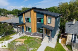 Modern duplex with dark blue and tan siding accents - 