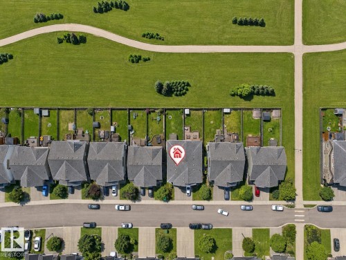Property featuring a gray shingle roof, paved driveway, and established landscaping - 1668 Chapman Way Sw, Edmonton, AB 