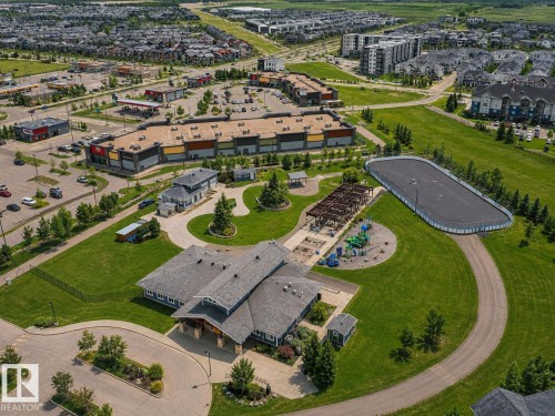 Expansive community grounds featuring a recreation center, paved pathways, and an outdoor rink - 1668 Chapman Way Sw, Edmonton, AB 