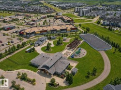 Expansive community grounds featuring a recreation center, paved pathways, and an outdoor rink - 