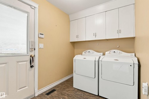 White paneled door with integrated window and digital lock - 14103 60 Avenue Nw, Edmonton, AB 