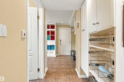 Built-in storage cabinetry with wire pull-out shelves, neutral wall color, and durable flooring - 14103 60 Avenue Nw, Edmonton, AB 