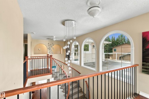 Arched windows, decorative light fixtures, wood-finish flooring, and arched wall niches - 14103 60 Avenue Nw, Edmonton, AB 